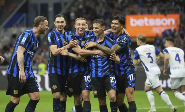 Inter Milan players celebrate after Inter Milan's Kristjan Asllani scored his side's opening goal during the Serie A soccer match between Inter Milan and Hellas Verona at the San Siro Stadium, in Milan, Italy, Saturday, May 3, 2025. (AP Photo/Antonio Calanni)
