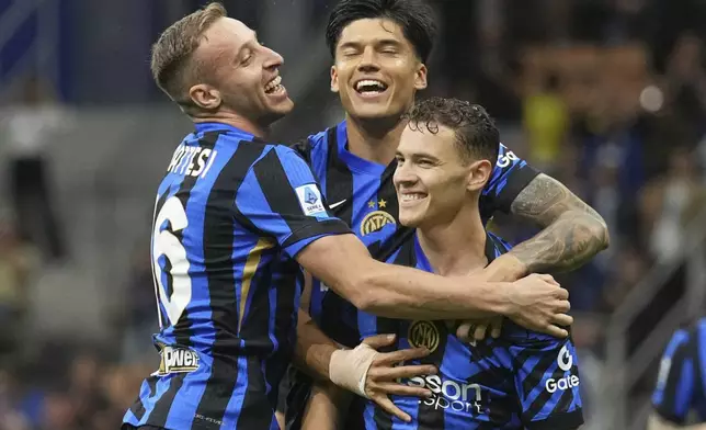 Inter Milan's Kristjan Asllani, right, celebrates with teammates after scoring his side's opening goal during the Serie A soccer match between Inter Milan and Hellas Verona at the San Siro Stadium, in Milan, Italy, Saturday, May 3, 2025. (AP Photo/Antonio Calanni)