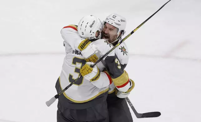 Vegas Golden Knights right wing Mark Stone (61) celebrates with defenseman Brayden McNabb (3) after scoring during the third period of Game 6 of a first-round NHL hockey playoff series against the Minnesota Wild, Thursday, May 1, 2025, in St. Paul, Minn. (AP Photo/Bailey Hillesheim)