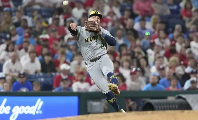 Milwaukee Brewers third baseman Caleb Durbin throws to first after fielding a ground out by Philadelphia Phillies' Trea Turner during the sixth inning of a baseball game Friday, May 30, 2025, in Philadelphia. (AP Photo/Matt Slocum)