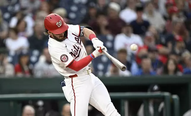 Washington Nationals' Dylan Crews hits a solo home run against Atlanta Braves pitcher Spencer Strider during the second inning of a baseball game in Washington, Tuesday, May 20, 2025. (AP Photo/Terrance Williams)