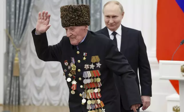 FILE - Russian President Vladimir Putin, right, looks at World War II veteran Ibragim-Pasha Sadykov, 101, after giving him the Hero of Russia award in the Kremlin's St. Catherine Hall in Moscow, Russia, on Thursday, May 30, 2024. (Vyacheslav Prokofyev, Sputnik, Kremlin Pool Photo via AP, File)