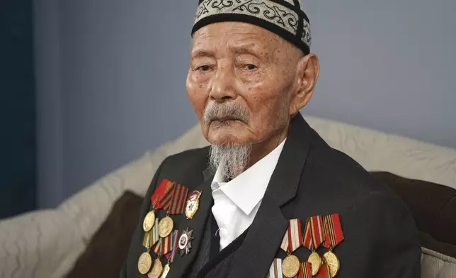 World War II veteran Kolbai Anafiryaev, 98, poses for a portrait in Almaty, Kazakhstan, on Tuesday, April 15, 2025. Anafiryaev was drafted into the Soviet army in 1944. (AP Photo/Vladimir Tretyakov)