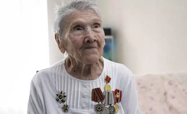 World War II veteran Olga Savenko, 101, poses for a portrait in Almaty, Kazakhstan, on Wednesday, April 16, 2025. Savenko joined the Soviet army on the front lines in 1941, when she was just 18, and served as a communications operator. (AP Photo/Vladimir Tretyakov)
