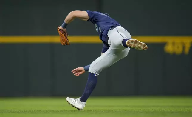 Seattle Mariners third baseman Ben Williamson makes a diving catch on a ball hit by Texas Rangers designated hitter Joc Pederson during the first inning of a baseball game Friday, May 2, 2025, in Arlington, Texas. (AP Photo/Julio Cortez)