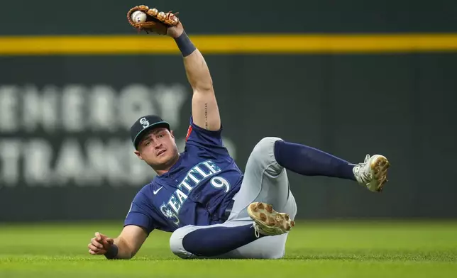 Seattle Mariners third baseman Ben Williamson reacts after making a diving catch on a ball hit by Texas Rangers designated hitter Joc Pederson for the final out of the first inning of a baseball game Friday, May 2, 2025, in Arlington, Texas. (AP Photo/Julio Cortez)