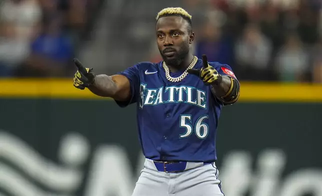 Seattle Mariners' Randy Arozarena reacts after collecting a double against the Texas Rangers during the fifth inning of a baseball game Friday, May 2, 2025, in Arlington, Texas. (AP Photo/Julio Cortez)