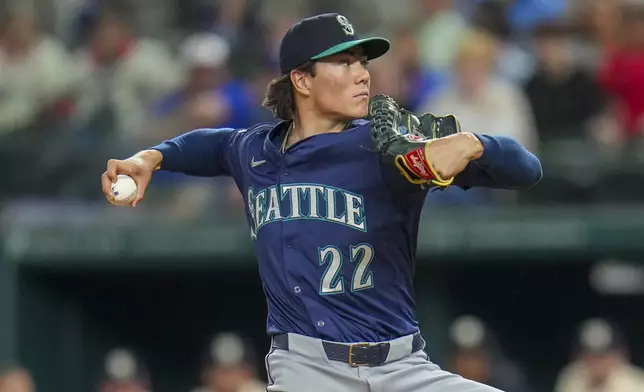Seattle Mariners starting pitcher Bryan Woo throws a pitch to the Texas Rangers during the first inning of a baseball game Friday, May 2, 2025, in Arlington, Texas. (AP Photo/Julio Cortez)