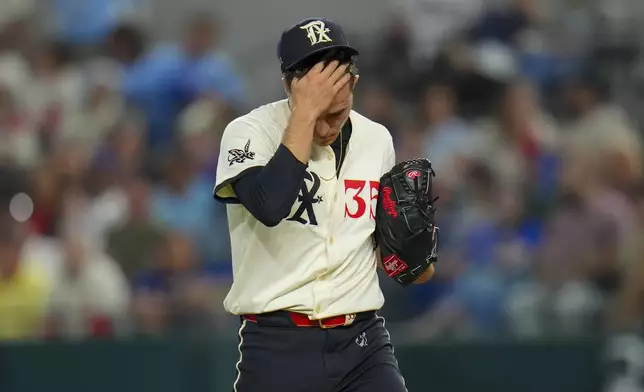 Texas Rangers starting pitcher Jack Leiter reacts between pitches against the Seattle Mariners during the first inning of a baseball game Friday, May 2, 2025, in Arlington, Texas. (AP Photo/Julio Cortez)