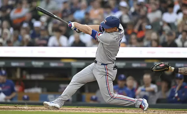 Texas Rangers' Corey Seager hits an RBI double against the Detroit Tigers during the fifth inning of a baseball game Saturday, May 10, 2025, in Detroit. (AP Photo/Lon Horwedel)