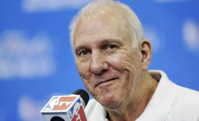 FILE - In this June 14, 2014, file photo, San Antonio Spurs head coach Gregg Popovich smiles as a question is asked during a news conference for the NBA basketball finals in San Antonio. (AP Photo/Tony Gutierrez, File)