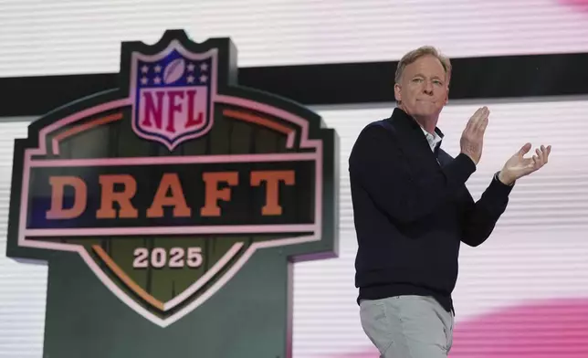 NFL Commissioner Roger Goodell motions on stage during the second round of the NFL football draft, Friday, April 25, 2025, in Green Bay, Wis. (AP Photo/Jeff Roberson)