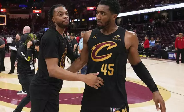 Cleveland Cavaliers guard Darius Garland, left, and guard Donovan Mitchell hug each other after the Indiana Pacers defeated the Cavaliers 114-105 in Game 5 of an Eastern Conference semifinal NBA basketball playoff Tuesday, May 13, 2025, in Cleveland. (AP Photo/Sue Ogrocki)