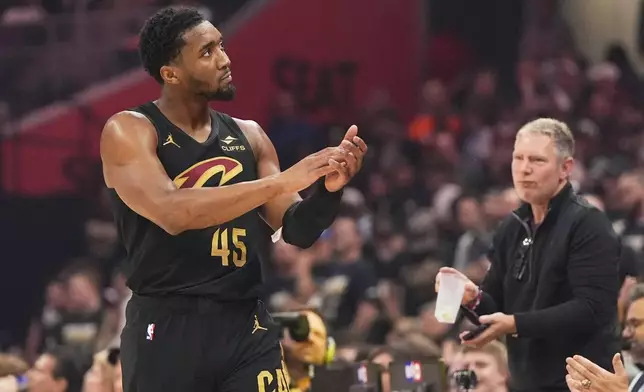 Cleveland Cavaliers guard Donovan Mitchell gestures to fans during the first half in Game 5 of an Eastern Conference semifinal NBA basketball playoff against the Indiana Pacers, Tuesday, May 13, 2025, in Cleveland. (AP Photo/Sue Ogrocki)