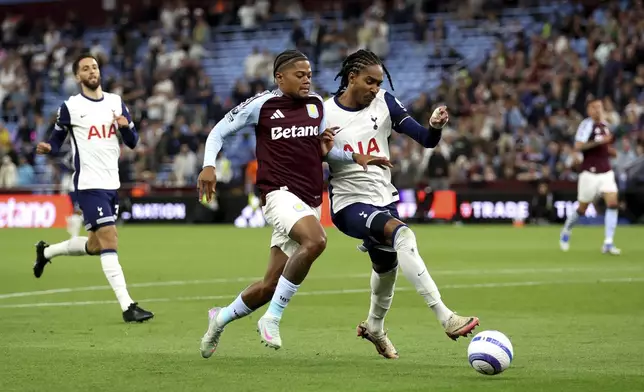 Aston Villa's Leon Bailey, left, and Tottenham Hotspur's Djed Spence battle for the ball during their English Premier League soccer match at Villa Park, Birmingham, England, Friday, May 16, 2025. (Nick Potts/PA via AP)