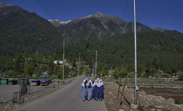 Kashmiri girls walk to school in Pahalgam in Indian controlled Kashmir, Thursday, May 16, 2025. (AP Photo/Dar Yasin)