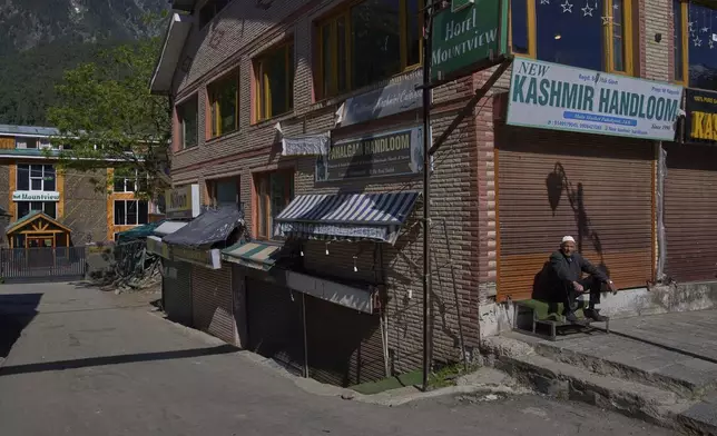 A Kashmiri man sits outside closed shops and hotels in Pahalgam, Indian controlled Kashmir, Thursday, May 16, 2025. (AP Photo/Dar Yasin)