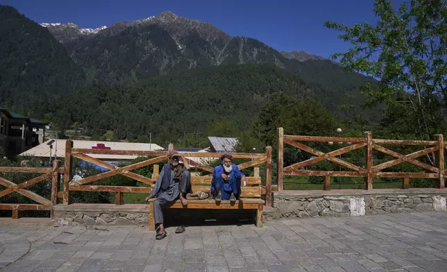 Kashmiri men sit at a deserted tourist spot in Pahalgam, Indian controlled Kashmir, Thursday, May 16, 2025. (AP Photo/Dar Yasin)