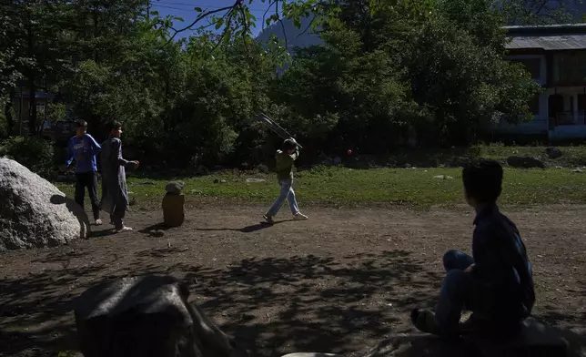 Kashmiri children play cricket in the border village of Gingal, north of Srinagar, Indian-controlled Kashmir, Wednesday, May 14, 2025. (AP Photo/Dar Yasin)