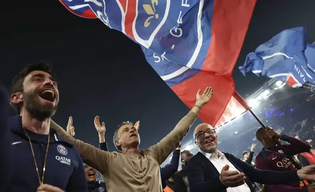 Paris Saint-Germain's headcoach Luis Enrique, center, celebrates PSG's French League One title after the League One soccer match between Paris Saint-Germain and Auxerre at the Parc des Princes stadium in Paris, Saturday, May 17, 2025. (Franck Fife/Pool via AP)