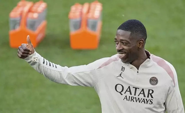 PSG's Ousmane Dembele gives a thumbs up during a training session ahead of the Champions League final soccer match between Paris Saint-Germain and Inter Milan in Munich, Germany, Friday, May 30, 2025. (AP Photo/Martin Meissner)