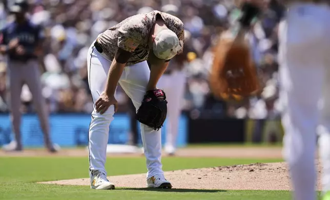 San Diego Padres starting pitcher Michael King looks down after an RBI single hit by Seattle Mariners' Miles Mastrobuoni deflected off him during the fourth inning of a baseball game Sunday, May 18, 2025, in San Diego. (AP Photo/Gregory Bull)