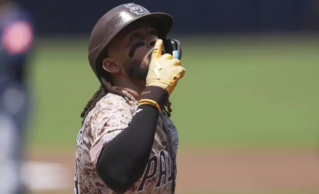 San Diego Padres' Fernando Tatis Jr. celebrates after hitting a home run during the first inning of a baseball game against the Seattle Mariners Sunday, May 18, 2025, in San Diego. (AP Photo/Gregory Bull)