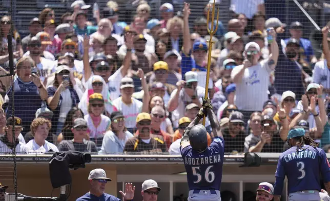 Seattle Mariners' Randy Arozarena (56) celebrates with fans after hitting a home run during the fourth inning of a baseball game against the San Diego Padres Sunday, May 18, 2025, in San Diego. (AP Photo/Gregory Bull)