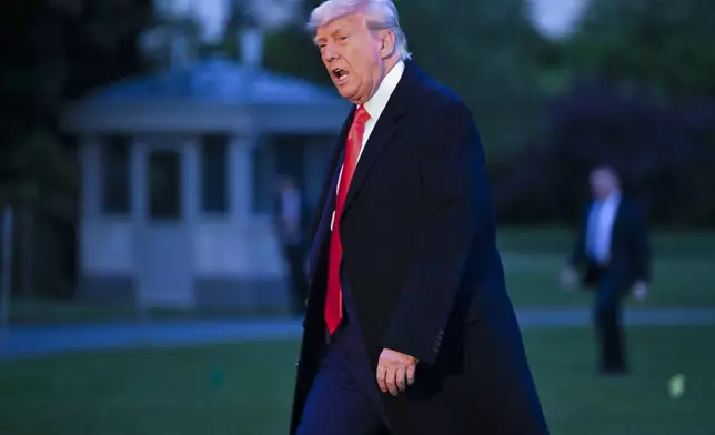 President Donald Trump arrives on the South Lawn of the White House, Thursday, May 22, 2025, in Washington, after attending a crypto dinner at Trump National Golf Club Washington DC. (AP Photo/John McDonnell)