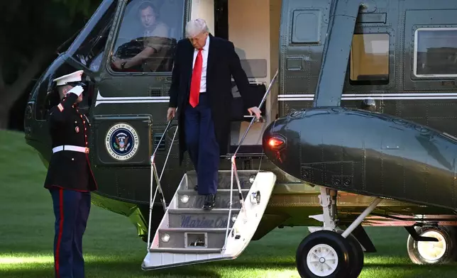 President Donald Trump arrives on the South Lawn of the White House, Thursday, May 22, 2025, in Washington, after attending a crypto dinner at Trump National Golf Club Washington DC. (AP Photo/John McDonnell)