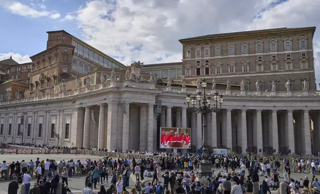 Faithful watch on a giant screen in St Peter's Square cardinals taking their oath at the start of the conclave to elect a new pope, at the Vatican, Wednesday, May 7, 2025. (AP Photo/Bernat Armangue)
