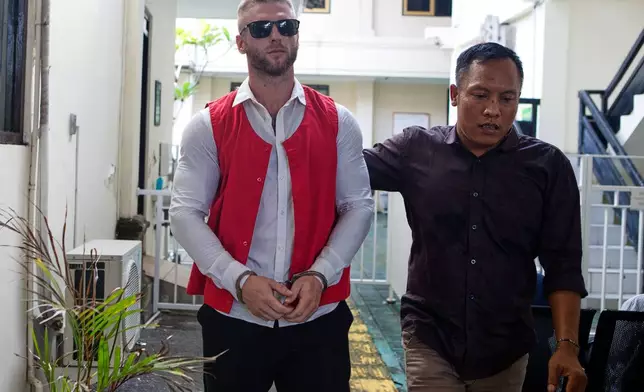 British citizen Thomas Parker walks towards a district court before he is sentenced for drug offenses, in Denpasar in Bali, Indonesia, Tuesday, May 27, 2025. (AP Photo/Firdia Lisnawati)