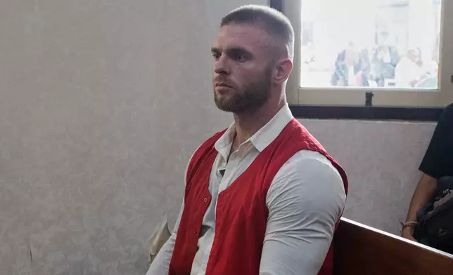 British citizen Thomas Parker, sentenced later for drug offenses, sits on the defendant's chair before the start of his verdict trial at a district court in Denpasar in Bali, Indonesia, Tuesday, May 27, 2025. (AP Photo/Firdia Lisnawati)