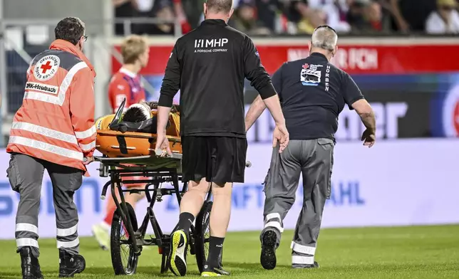 Heidenheim goalkeeper Kevin Müller is carried off on a stretcher following an injury in the Bundesliga soccer match between FC Heidenheim and VfL Bochum at Voith-Arena. Heidenheim, Germany, Friday May 2, 2025. (Harry Langer/dpa via AP)