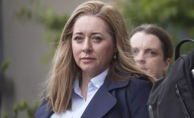 Journalist Jennifer O'Leary walks outside the High Court where where former Sinn Fein president Gerry Adams is bringing a legal action against the BBC over allegations about the murder of an MI5 spy in 2006, in Dublin, Ireland, Wednesday May 28, 2025. (Brian Lawless/PA via AP)