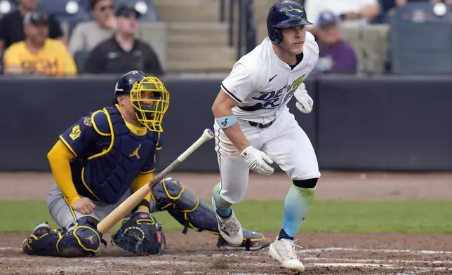 Tampa Bay Rays' Taylor Walls, right, watches his RBI double off Milwaukee Brewers pitcher Tobias Myers during the fourth inning of a baseball game Saturday, May 10, 2025, in Tampa, Fla. (AP Photo/Chris O'Meara)