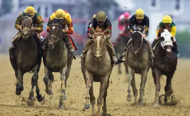 FILE- Red Bullet (4), with jockey Jerry Bailey aboard, center, breaks away from the field in the stretch to win 125th running of the Preakness Stakes at Pimlico Race Course in Baltimore, Saturday, May 20, 2000. (AP Photo/Roberto Borea, File)