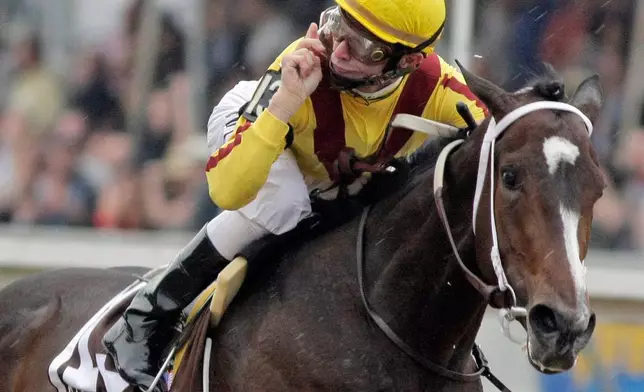 FILE - Jockey Calvin Borel gestures as he rides Rachel Alexandra to victory in the 134th running of the Preakness Stakes horse race at Pimlico Race Course, Saturday, May 16, 2009, in Baltimore. (AP Photo/Garry Jones, File)