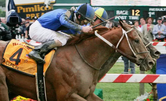 FILE - Curlin (4), ridden by Robby Albarado, passes Street Sense, ridden by Calvin Borel, to win the 132nd running of the Preakness Stakes horse race at Pimlico Race Course in Baltimore, Saturday, May 19, 2007. (AP Photo/J. David Ake, File)