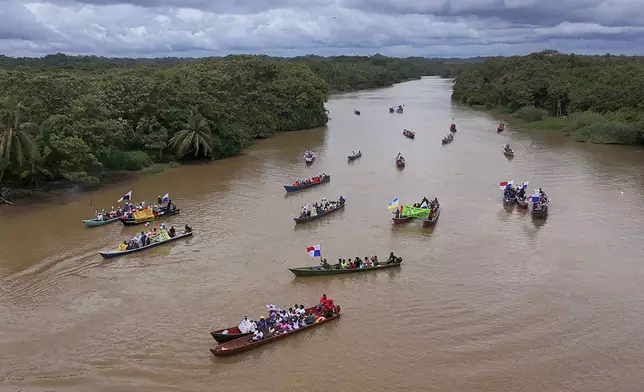 Demonstrators travel by river to the mouth of the Rio Indio on Panama's Caribbean coast to protest against a planned reservoir for the Panama Canal and to protest against Panamanian President Jose Raul Mulino, Friday, May 16, 2025. (AP Photo/Matias Delacroix)