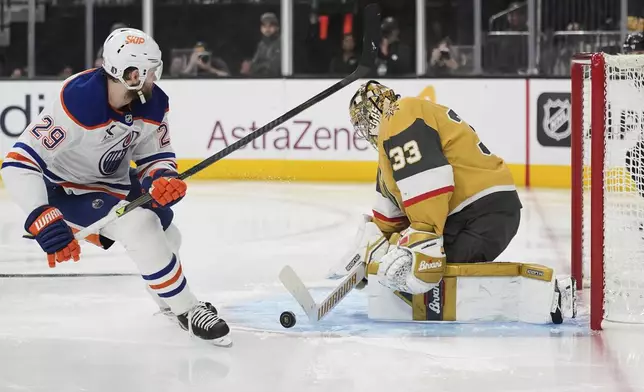 Vegas Golden Knights goaltender Adin Hill (33) blocks a shot by Edmonton Oilers center Leon Draisaitl (29) during the third period of Game 5 of a second-round NHL hockey playoff series Wednesday, May 14, 2025, in Las Vegas. (AP Photo/John Locher)