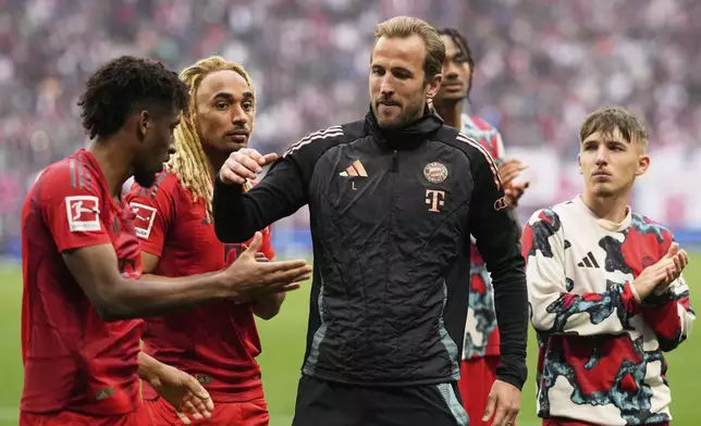 Bayern's Harry Kane, center, shakes hands with his teammates on the pitch at the end of the German Bundesliga soccer match between RB Leipzig and FC Bayern Munich at the Red Bull Arena in Leipzig, Germany, Saturday, May 3, 2025. (AP Photo/Matthias Schrader)