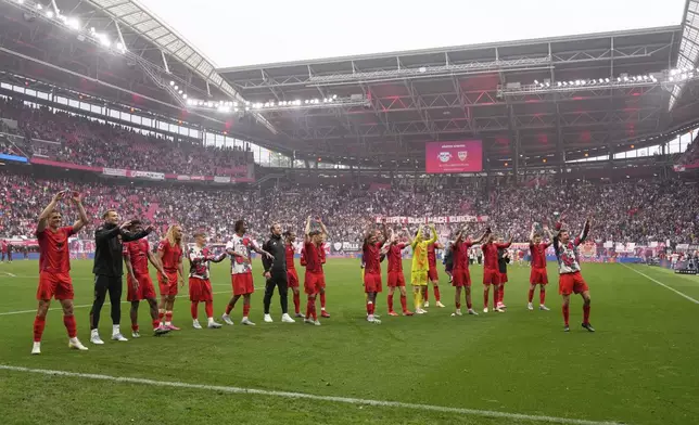 Bayern players thank the fans at the end of the German Bundesliga soccer match between RB Leipzig and FC Bayern Munich at the Red Bull Arena in Leipzig, Germany, Saturday, May 3, 2025. (AP Photo/Matthias Schrader)