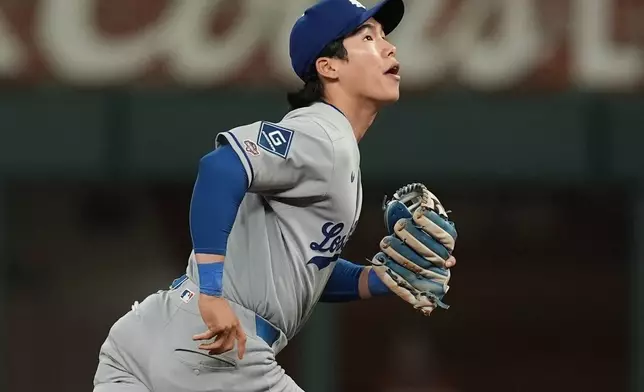 Los Angeles Dodgers' Hyeseong Kim defends against the Atlanta Braves in the ninth inning of a baseball game, Sunday, May 4, 2025, in Atlanta. (AP Photo/Mike Stewart)