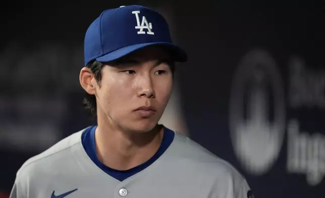 Los Angeles Dodgers' Hyeseong Kim stands in the dugout in the ninth inning of a baseball game against the Atlanta Braves, Sunday, May 4, 2025, in Atlanta. (AP Photo/Mike Stewart)