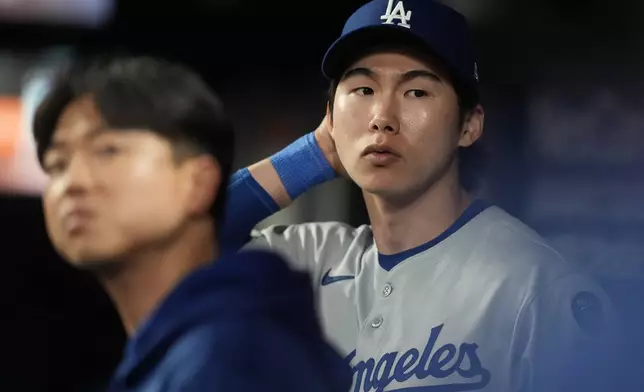 Los Angeles Dodgers' Hyeseong Kim stands in the dugout in the ninth inning of a baseball game against the Atlanta Braves, Sunday, May 4, 2025, in Atlanta. (AP Photo/Mike Stewart)
