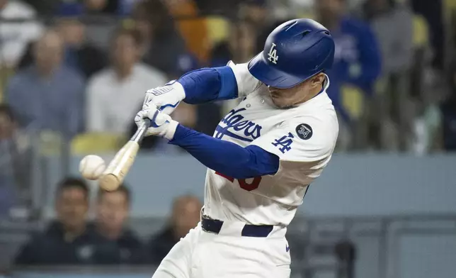 Los Angeles Dodgers' Tommy Edman hits a two-run double during the sixth inning of a baseball game against the Miami Marlins in Los Angeles, Tuesday, April 29, 2025. (AP Photo/Kyusung Gong)