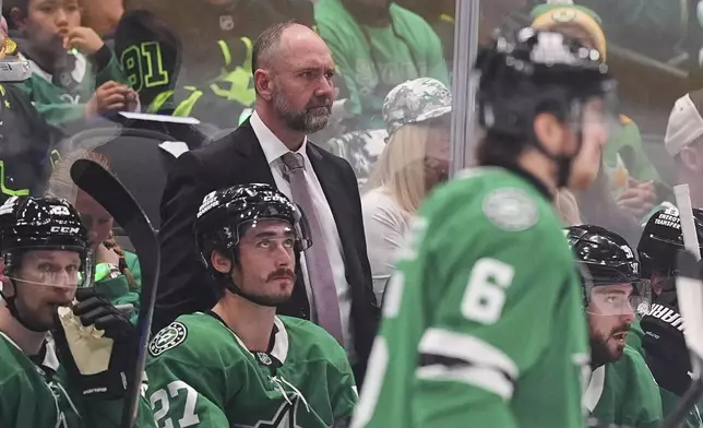 Dallas Stars head coach Pete DeBoer, center, watches play against the Winnipeg Jets in the second period of Game 3 of a second-round NHL hockey playoff series in Dallas, Sunday, May 11, 2025. (AP Photo/Julio Cortez)
