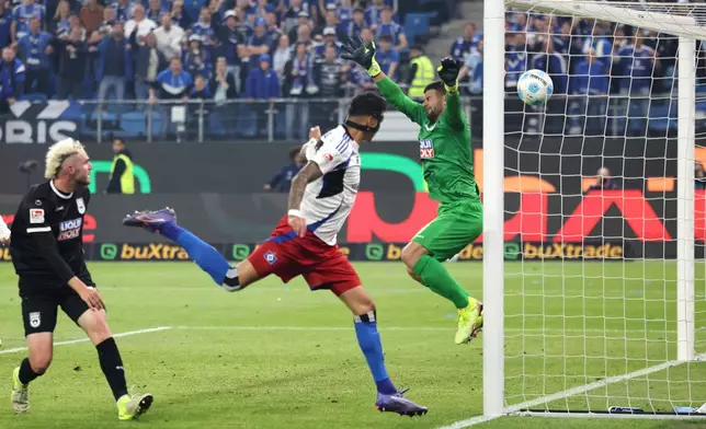 Hamburg's Davie Selke, center, scores a goal to make it 3:1 during the soccer game between Hamburger SV and SSV Ulm 1846 in Hamburg, Germany, on Saturday, May 10, 2025. (Christian Charisius/dpa via AP)