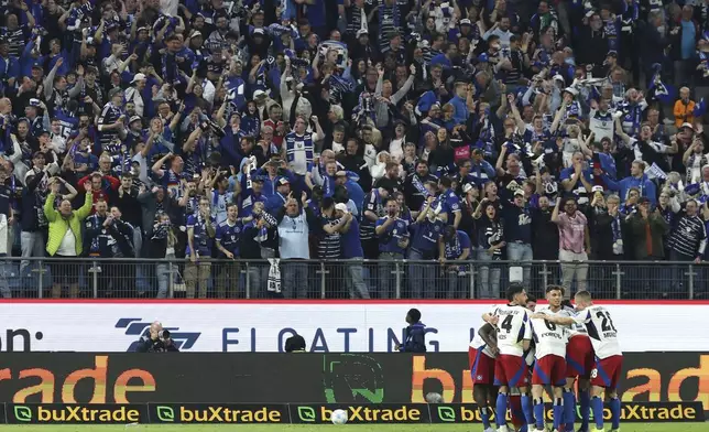 Hamburg's players and fans celebrate after scoring their fifth goal during a Bundesliga 2 soccer game between Hamburger SV and SSV Ulm 1846 in Hamburg, Germany, Saturday, May 10, 2025. (Christian Charisius/dpa via AP)